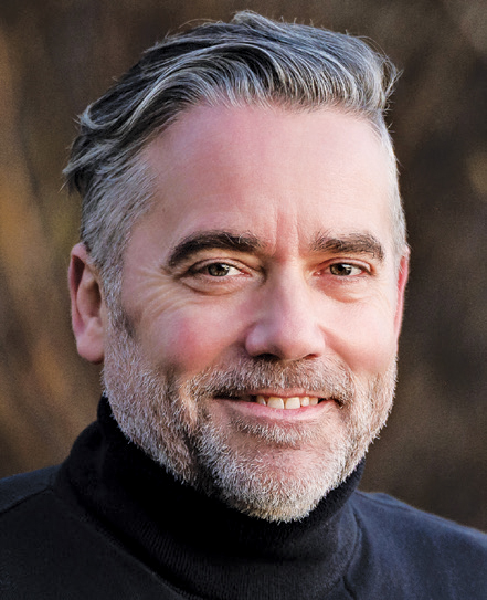 A headshot of Dr Adam Thompson.