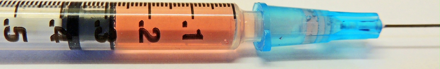 Figure 1. The usual withdrawal of 0.30 mL of fluid (red wine in this illustration) into a standard 25 g 1.5 inch syringe/needle leaves 0.08 mL in the dead space of the needle housing.