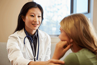 A doctor consults with a young patient