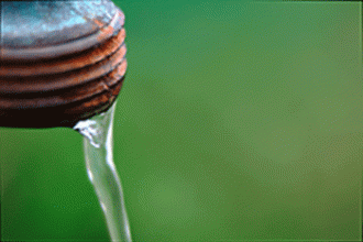 A bottle of water against a green background
