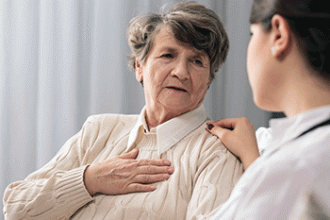 A doctor talks to a senior woman with a blank look on her face