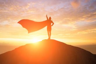 A silhouette of a woman with a superhero cape