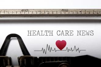 A sheet of paper on a typewriter that reads "Health Care News"