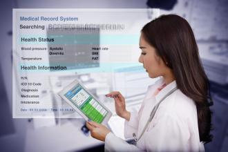 A doctor enters data in an electronic medical records system