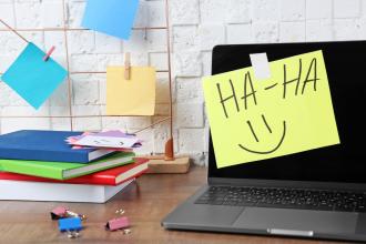 A computer with a Post-it note that says "haha"