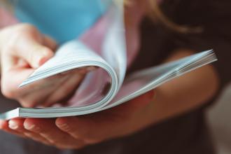 A woman reads a magazine