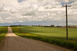 A country road with houses in the distance
