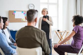 A facilitator leads a group therapy session.