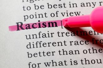 A page from a dictionary with the word "racism" highlighted