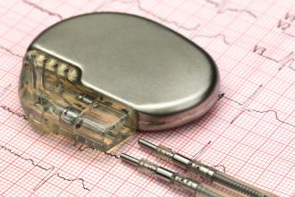 A pacemaker sits on top of an electrocardiograph