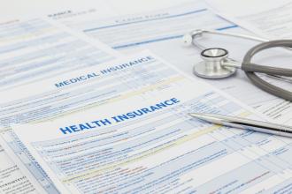 Health insurance forms sit on a table