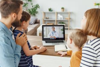 A family consults with their doctor by videoconference