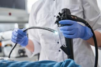 A doctor using an endoscope on a patient