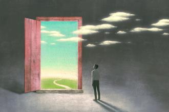 A person looks through an open door to the outside
