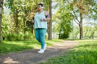 An overweight woman jogging