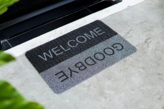 A welcome mat with "Welcome" in one direction and "Goodbye" in the other