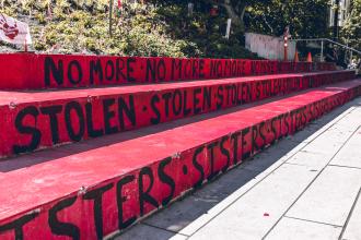 Concrete steps painted red with the words "No more stolen sisters"