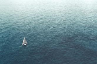 A sailboat heading out to sea