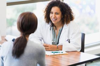 A doctor consults with a patient.