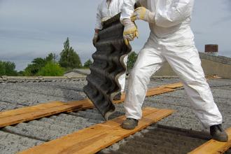 Crew removing asbestos roofing