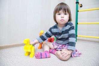 Child playing with lego like dinosaurs