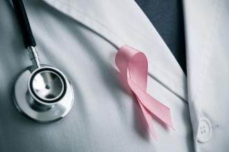 Doctor wearing a pink ribbon