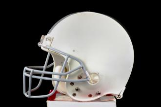 football helmet atop a pile of books