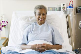 Senior Woman Sitting In Hospital Bed