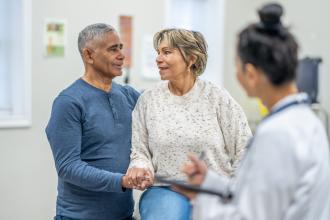 Older couple speaking with their physician