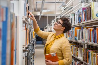 Librarian looking through the stacks