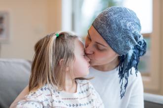 Young mom with cancer holds her daughter 