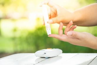 young lady using a lancet to monitor blood sugar levels