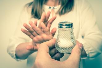 Girl stopping the intake of salt in her diet