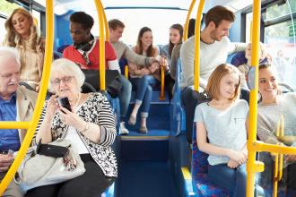 Interior of the bus full of happy bus riders