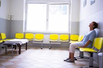 Lady sitting in a waiting room, impatient patient