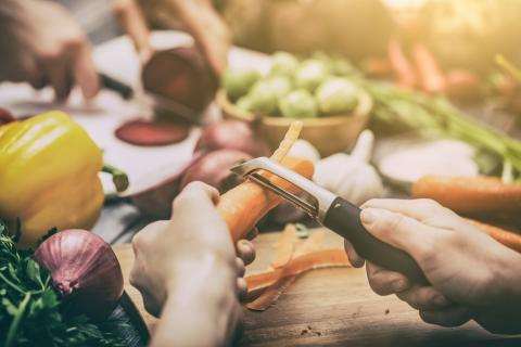 Two people preparing vegetables.