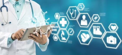 A collection of medical icons superimposed over a doctor holding a tablet