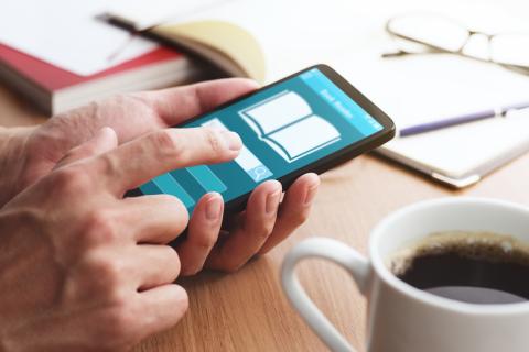 A doctor uses a smartphone to access a resource library