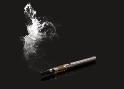 An electronic cigarette and a cloud of smoke