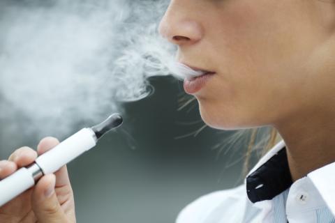 A person inhales from an e-cigarette