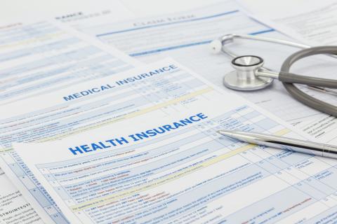 Health insurance forms sit on a table