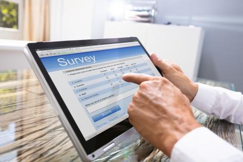 A doctor completes a survey on a tablet