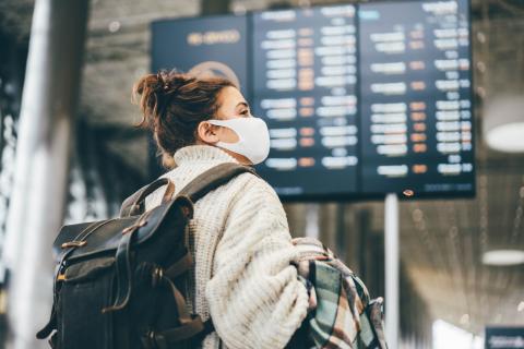 A traveler sits in a seat at the airport