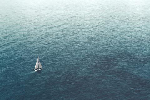 A sailboat heading out to sea