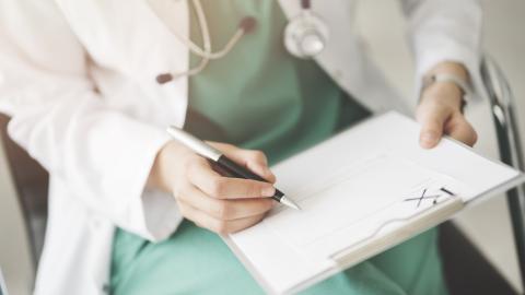 A doctor writes a prescription.