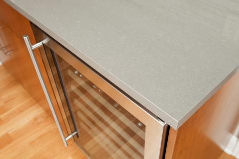 An engineered stone countertop above a cooler.