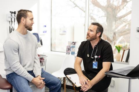 A doctor consults with a patient.