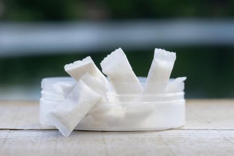 A plastic container of nicotine pouches.