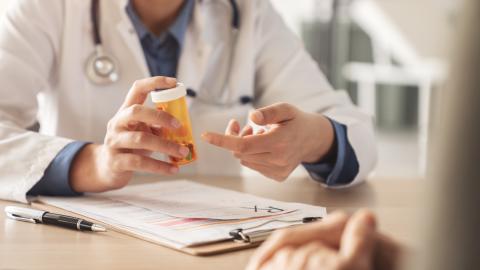 A doctor explains a prescription to a patient.