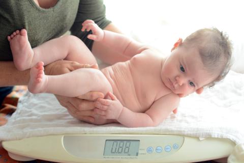 new-born-being-weighed